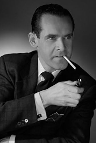 Studio portrait of man igniting cigarette with cigarette lighter Poster Print (18 x 24)   price checker   price checker